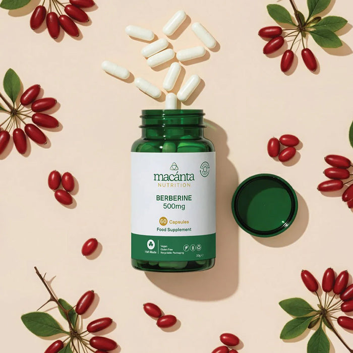 Macanta Berberine supplement bottle with capsules and red berries on a beige background